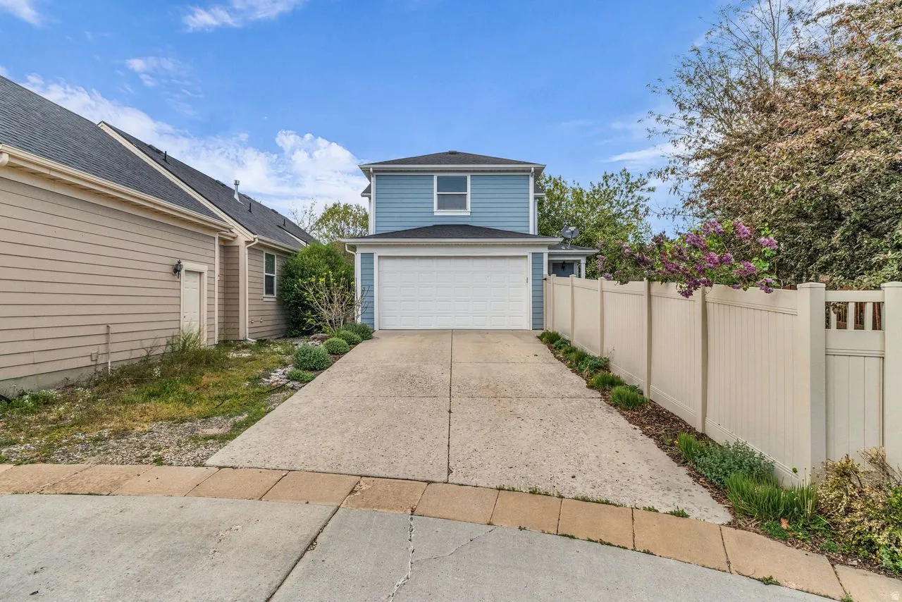 Two car garage featuring concrete driveway