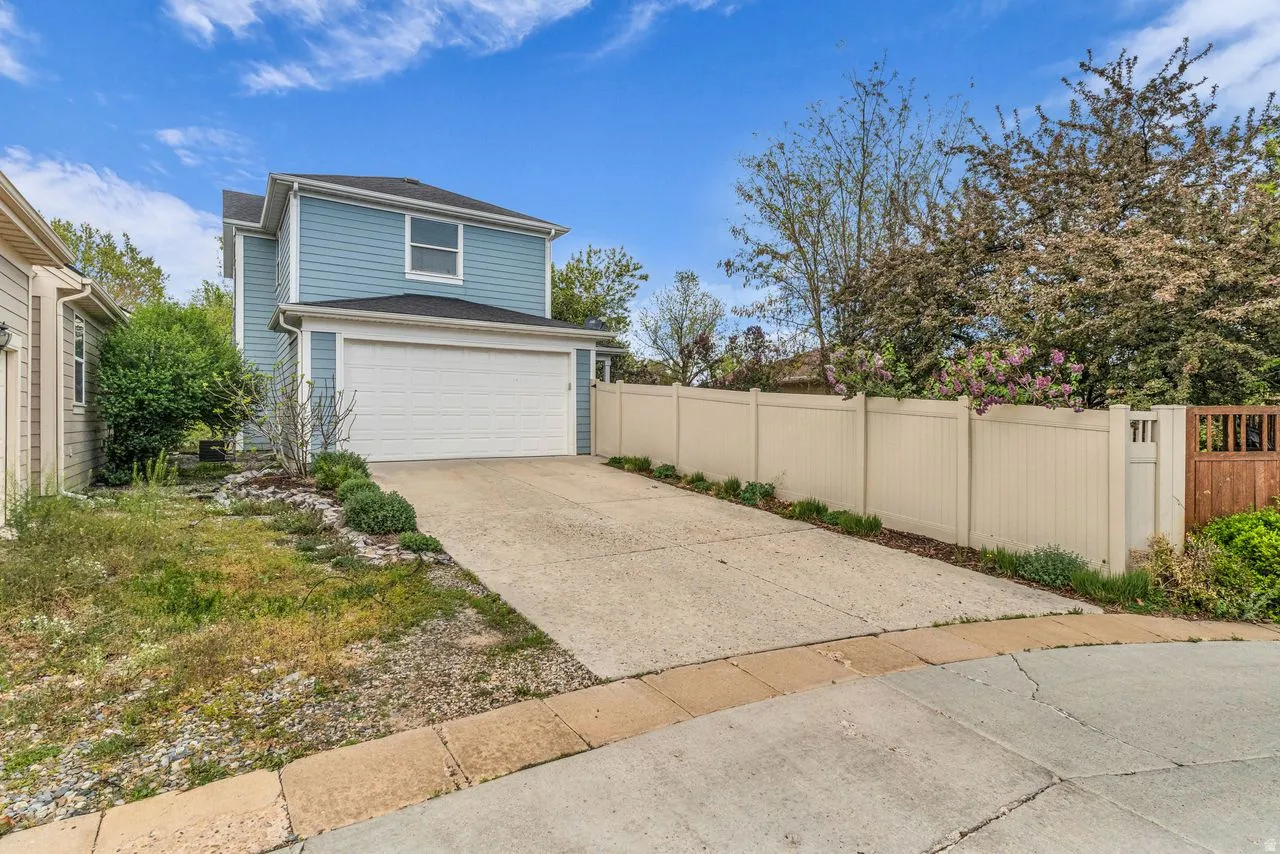 Garage featuring concrete driveway