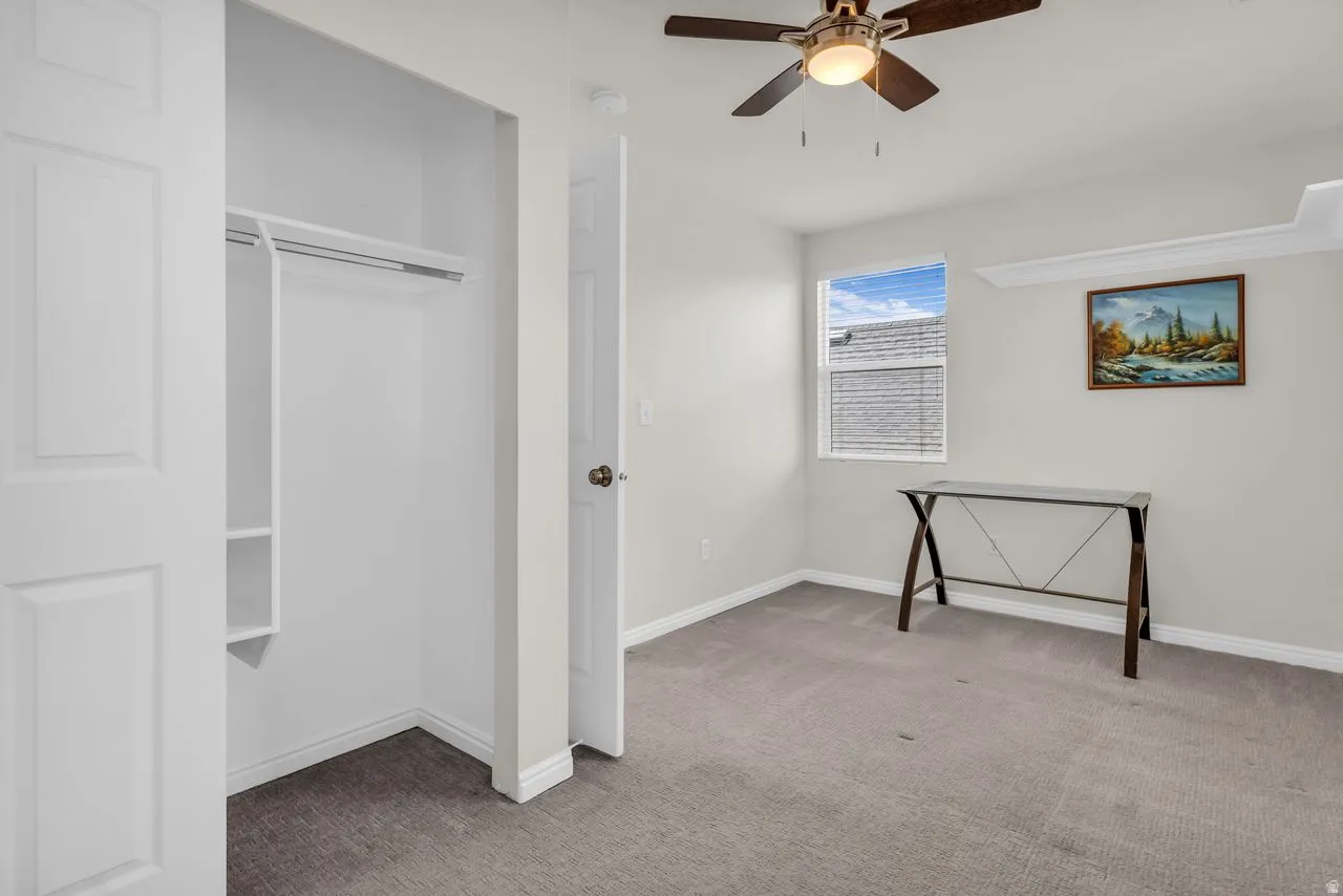 Bedroom with light carpet and ceiling fan