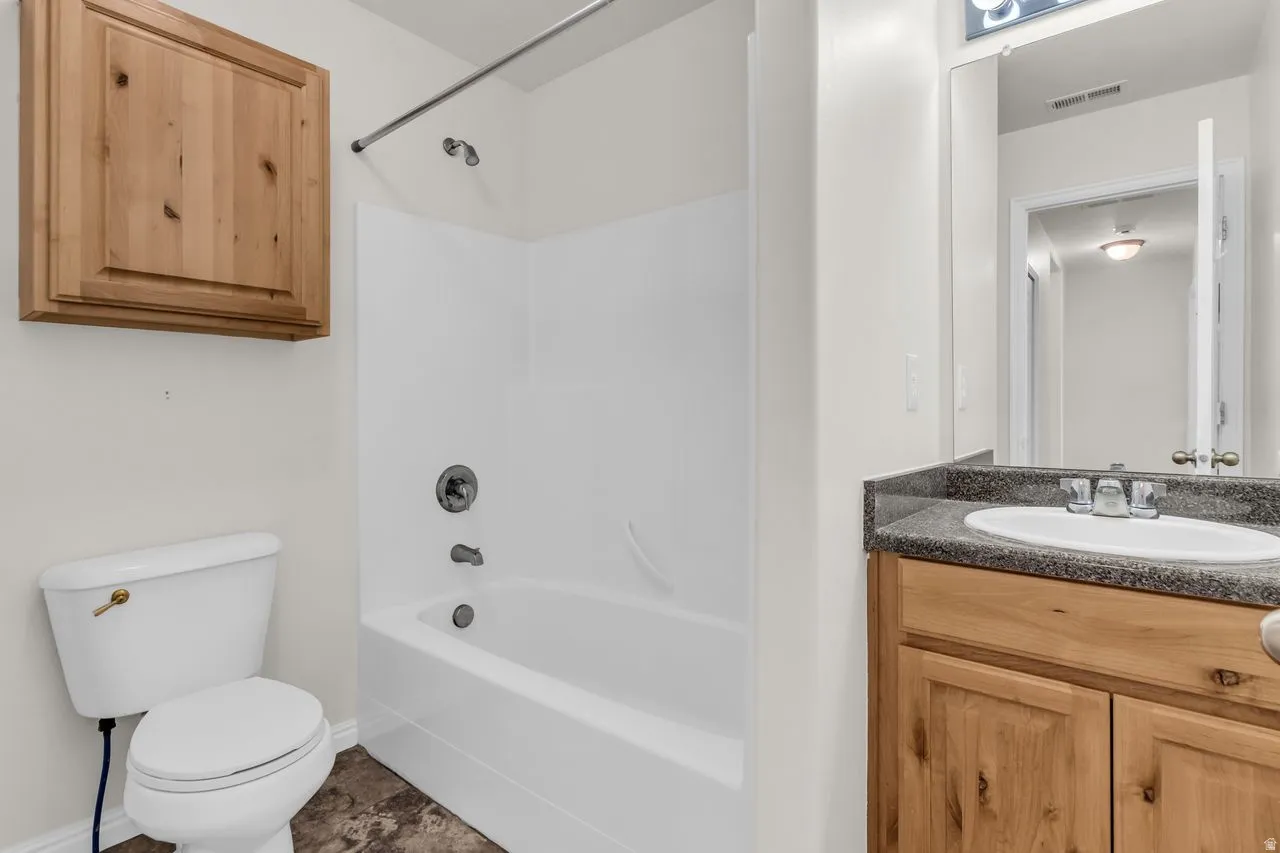 Full bathroom featuring vanity and shower-tub combination