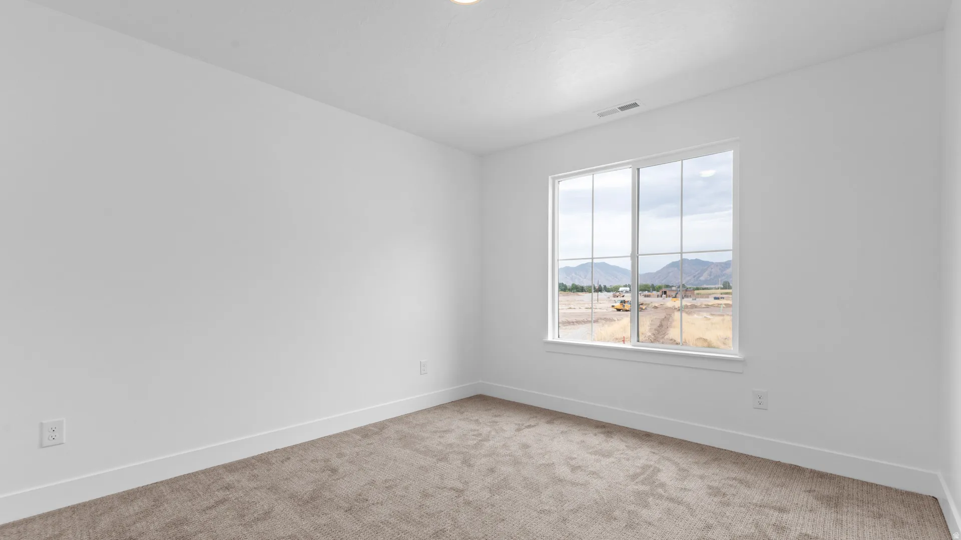 Bright room with a large window, plush carpet, white walls, and white trim