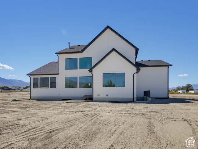 Contemporary exterior with crisp white siding and dark trim accents