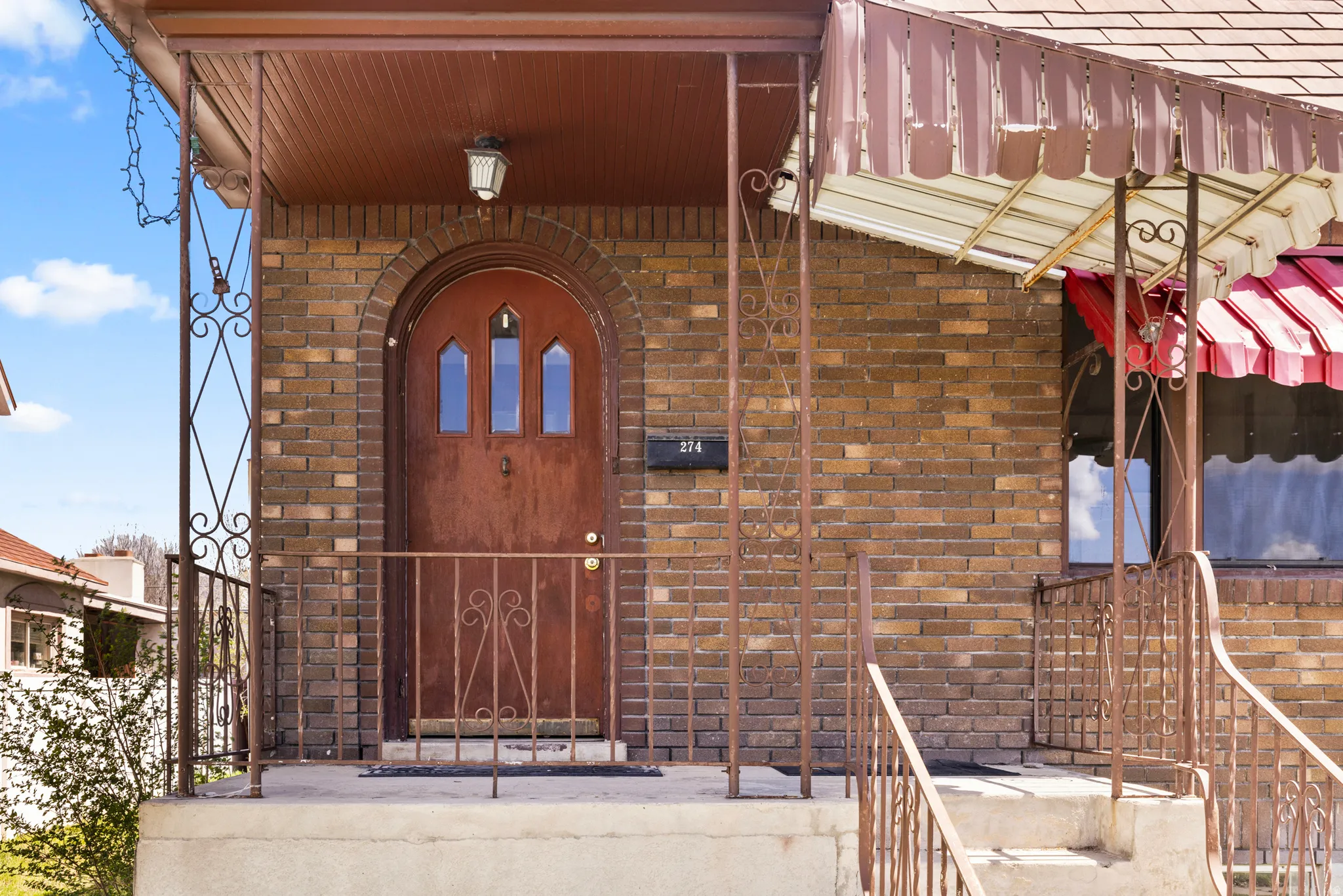 View of exterior entry featuring brick siding