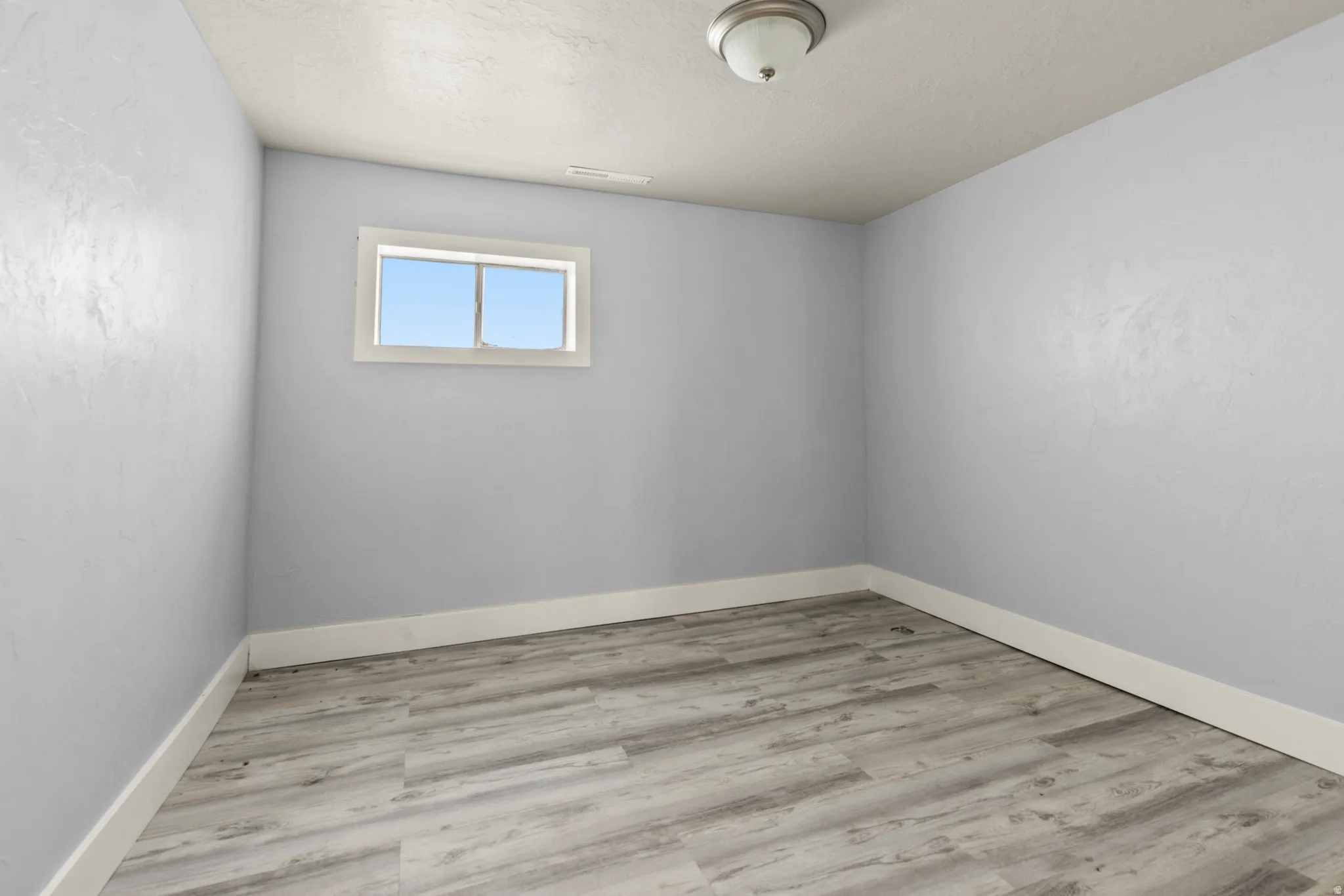 Empty room with light wood-style flooring