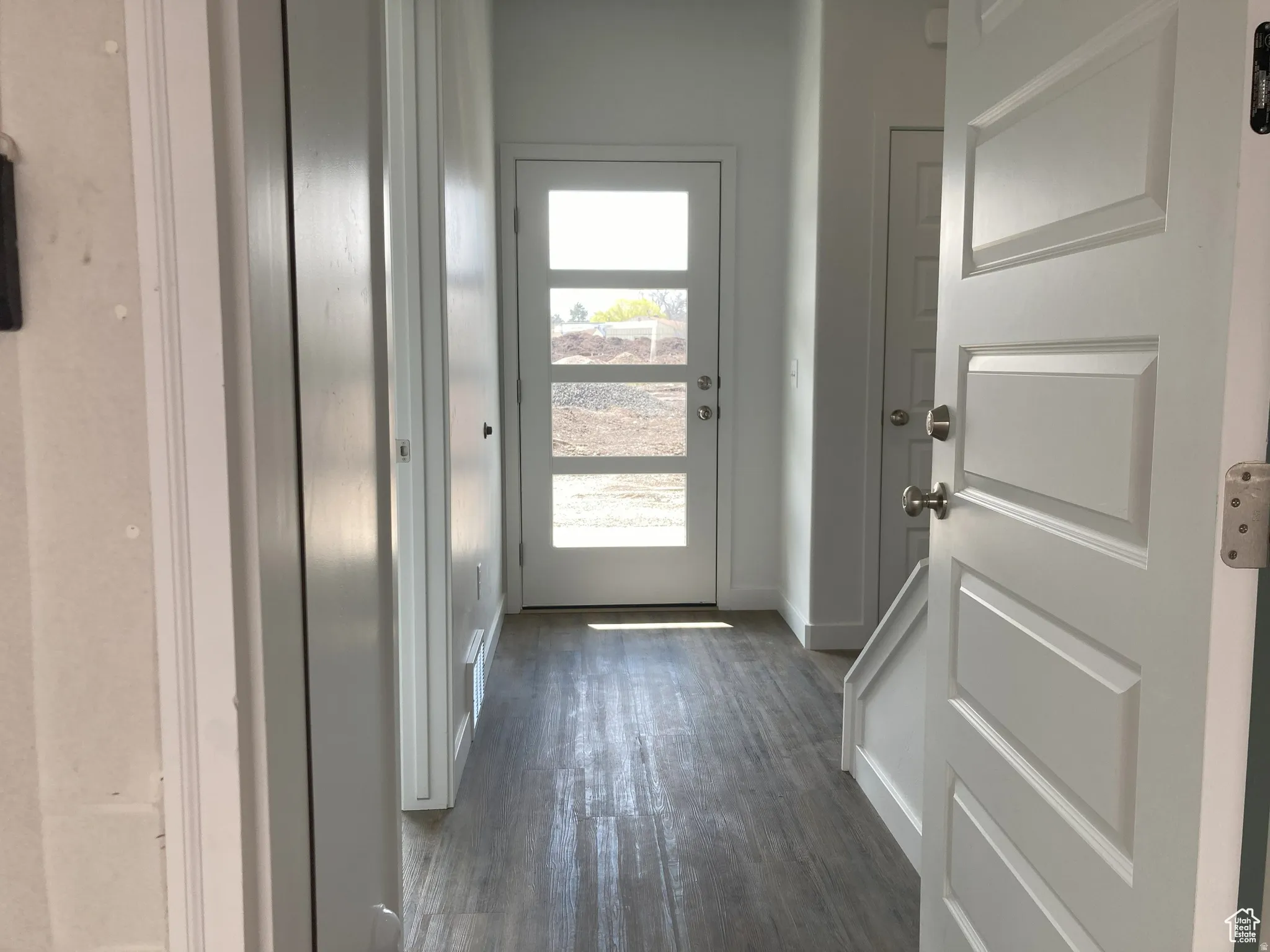 Entryway featuring wood finished floors and baseboards