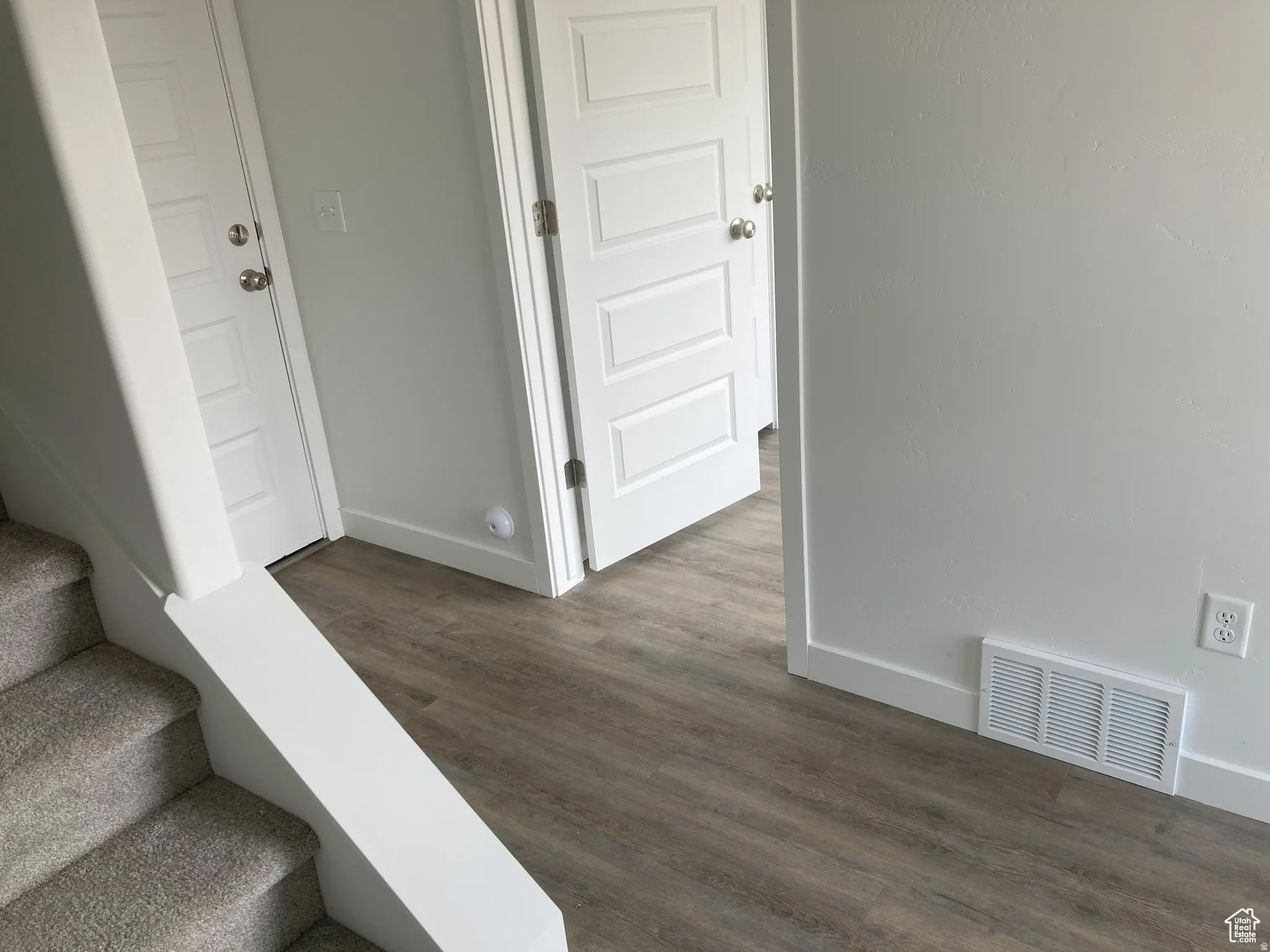 Stairs with baseboards and wood finished floors