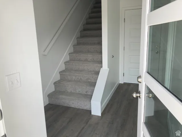 Staircase featuring wood finished floors