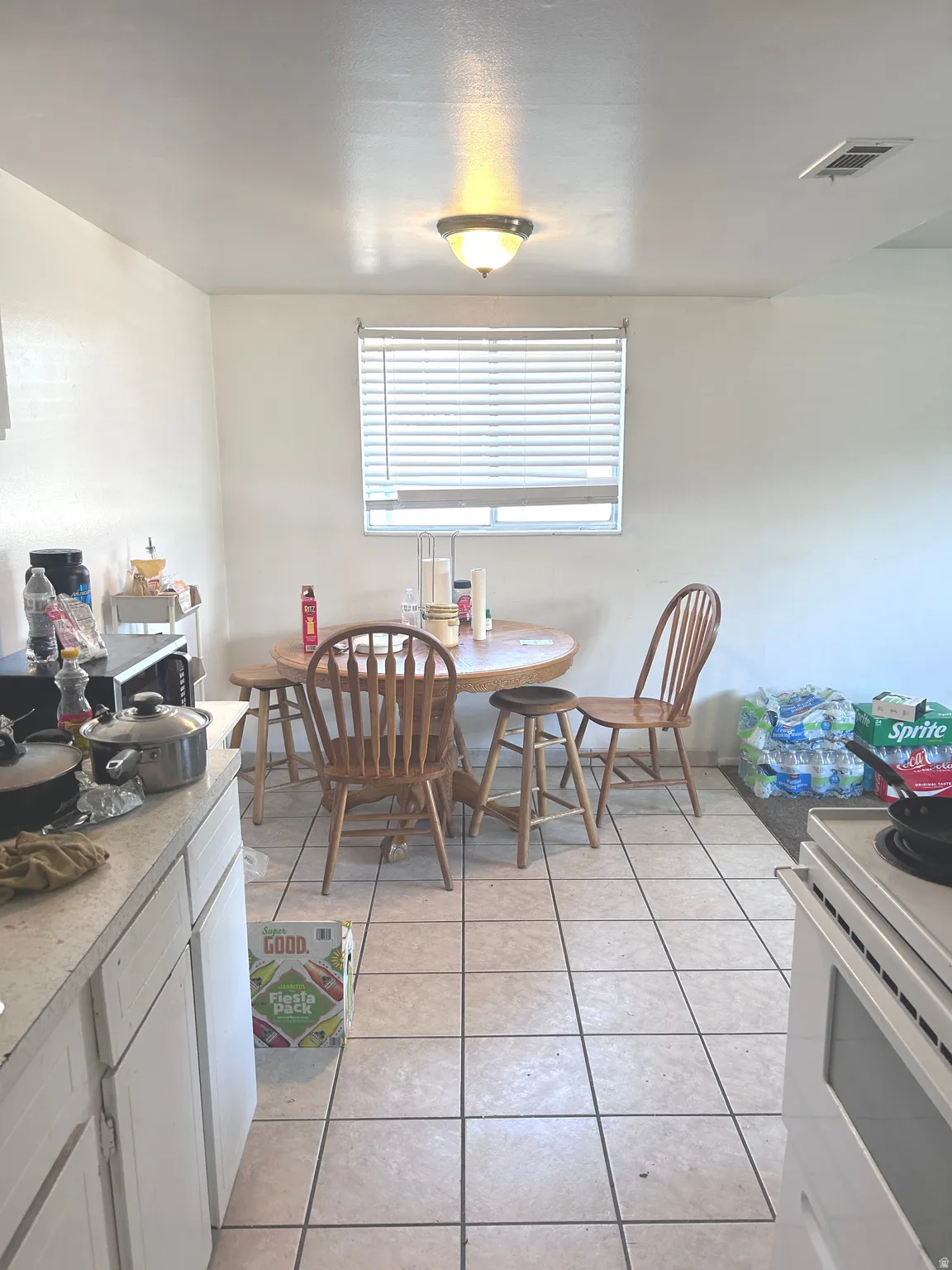 Dining space with light tile patterned flooring