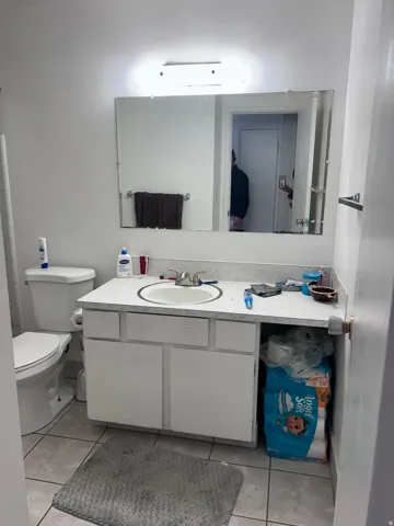 Bathroom with vanity and light tile patterned flooring