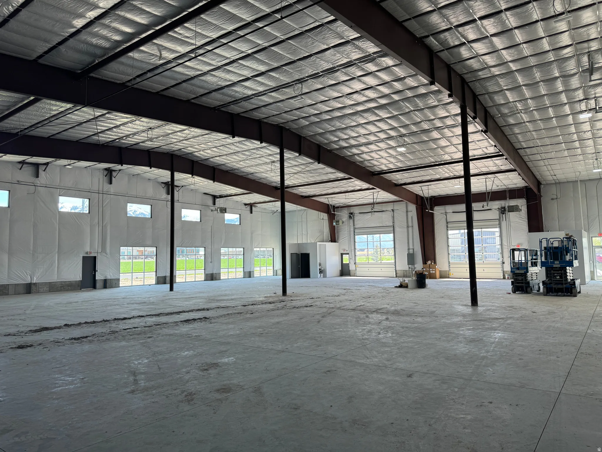 Misc room with a garage and a high ceiling