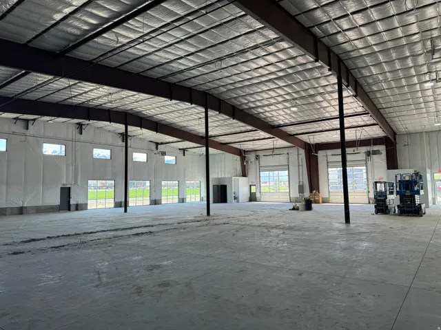 Misc room with a garage and a high ceiling