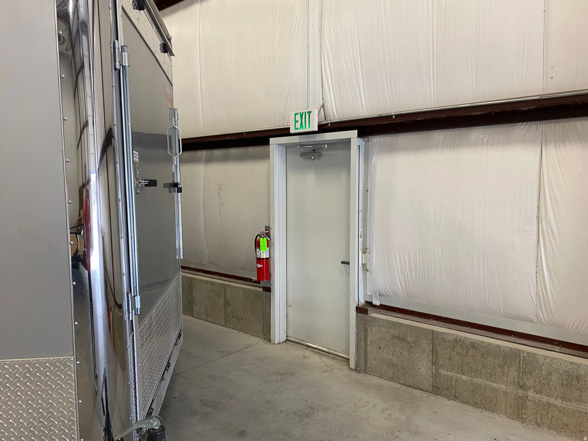 Detailed view of unfinished concrete flooring and a fire extinguisher