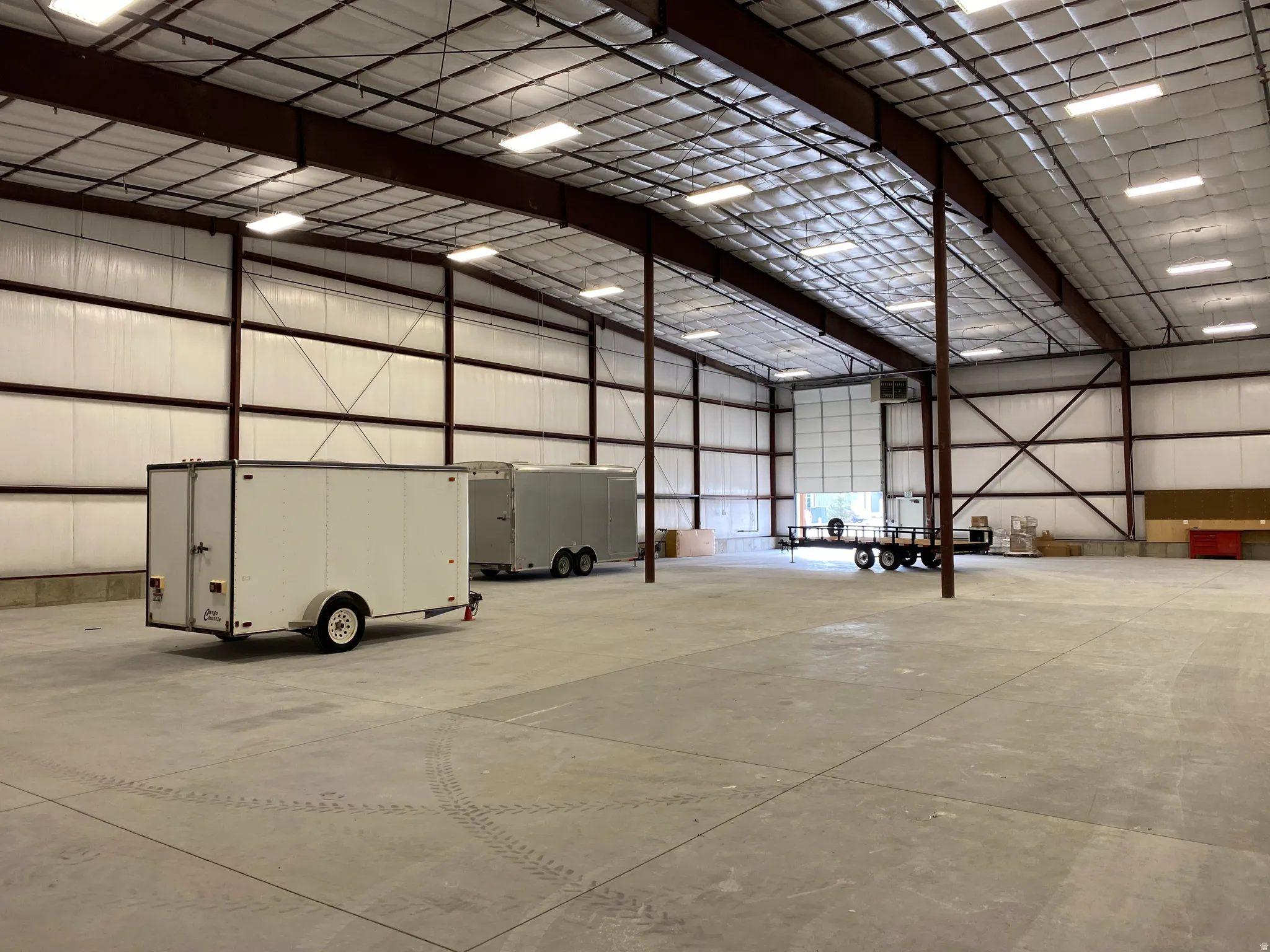 Garage featuring metal wall and a heating unit