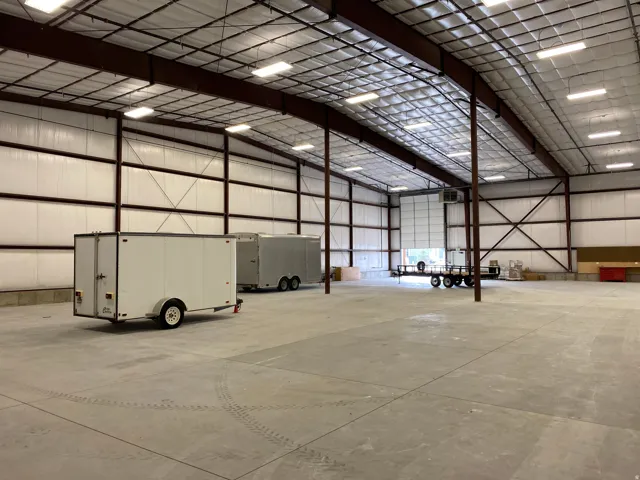 Garage featuring metal wall and a heating unit