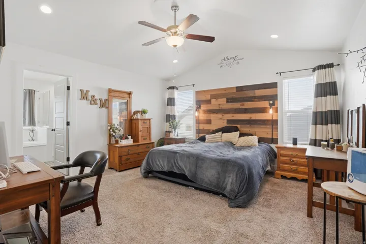 Bedroom featuring light colored carpet, recessed lighting, ceiling fan, and ensuite bathroom