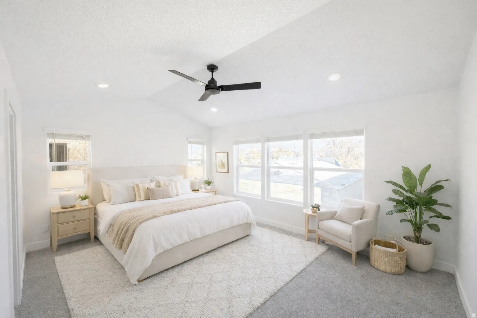 Bedroom with vaulted ceiling, light colored carpet, a ceiling fan, multiple windows, and recessed lighting