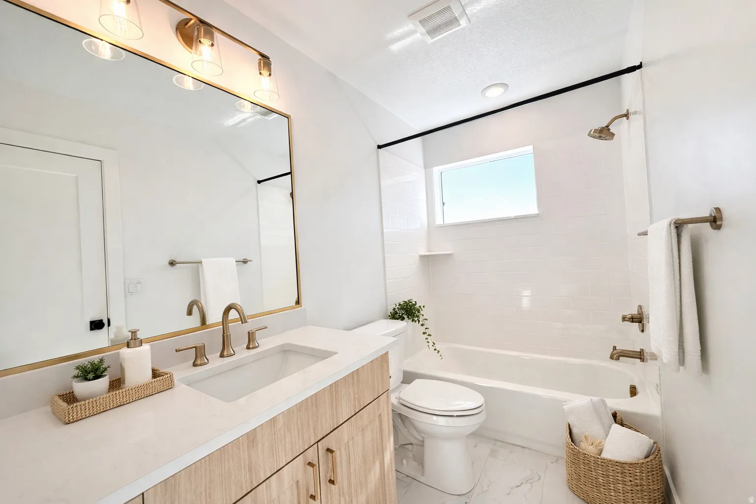 Full bath featuring vanity,  shower combination, and light marble finish flooring