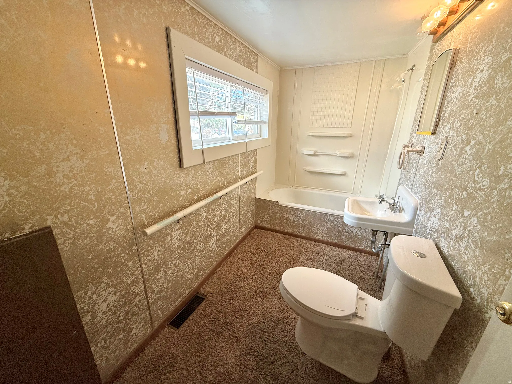 Full bath featuring wallpapered walls and shower / bathtub combination