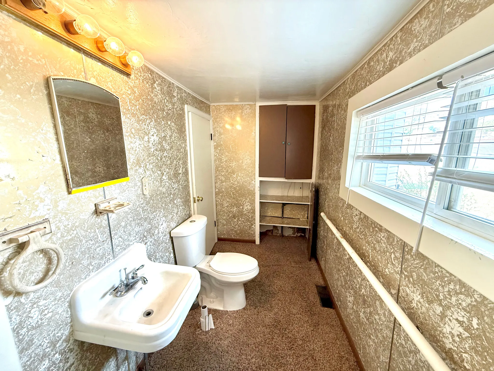 Bathroom with toilet and crown molding