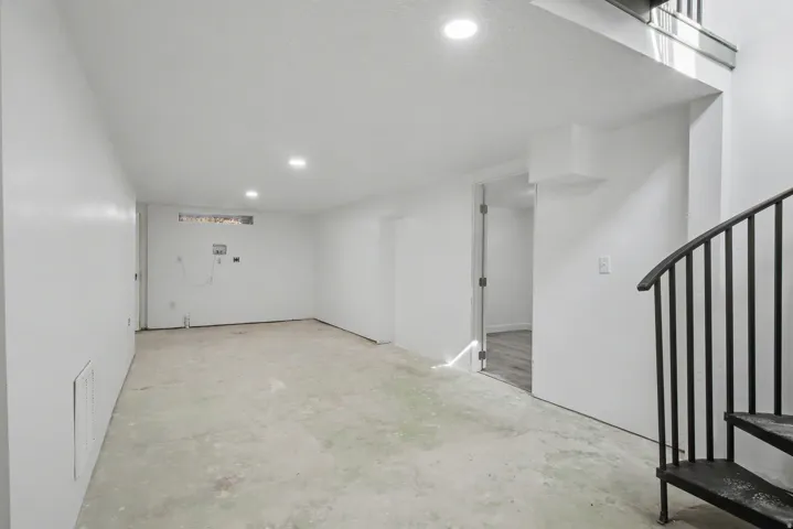 Below grade area featuring stairs and recessed lighting