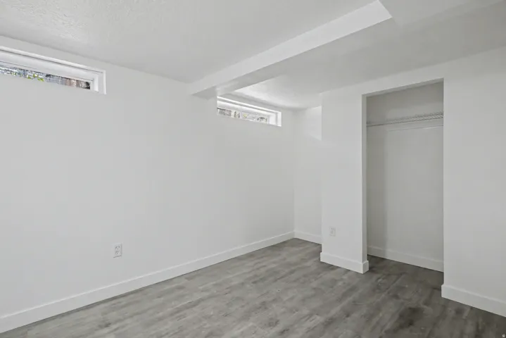 Unfurnished bedroom with a closet and wood finished floors