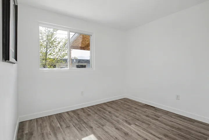 Spare room with wood finished floors and baseboards