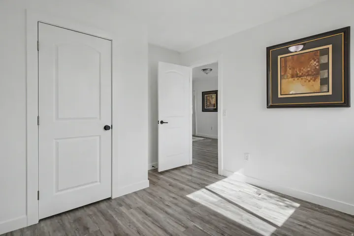 Unfurnished bedroom with light wood-type flooring and baseboards