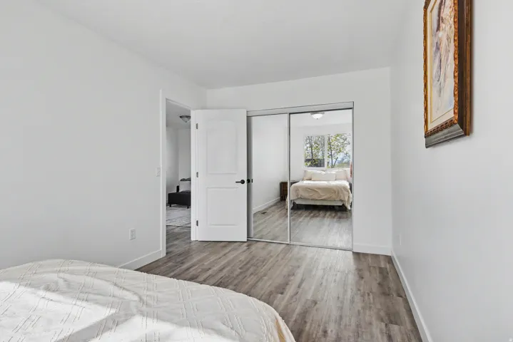Bedroom featuring wood finished floors and a closet
