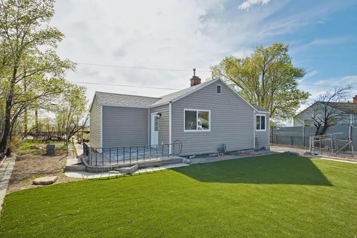 Back of property with a chimney and a patio area