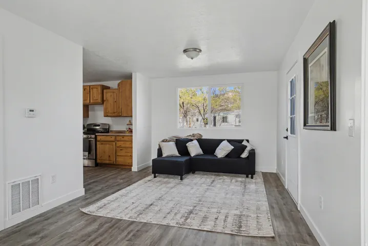 Living area featuring dark wood finished floors and baseboards