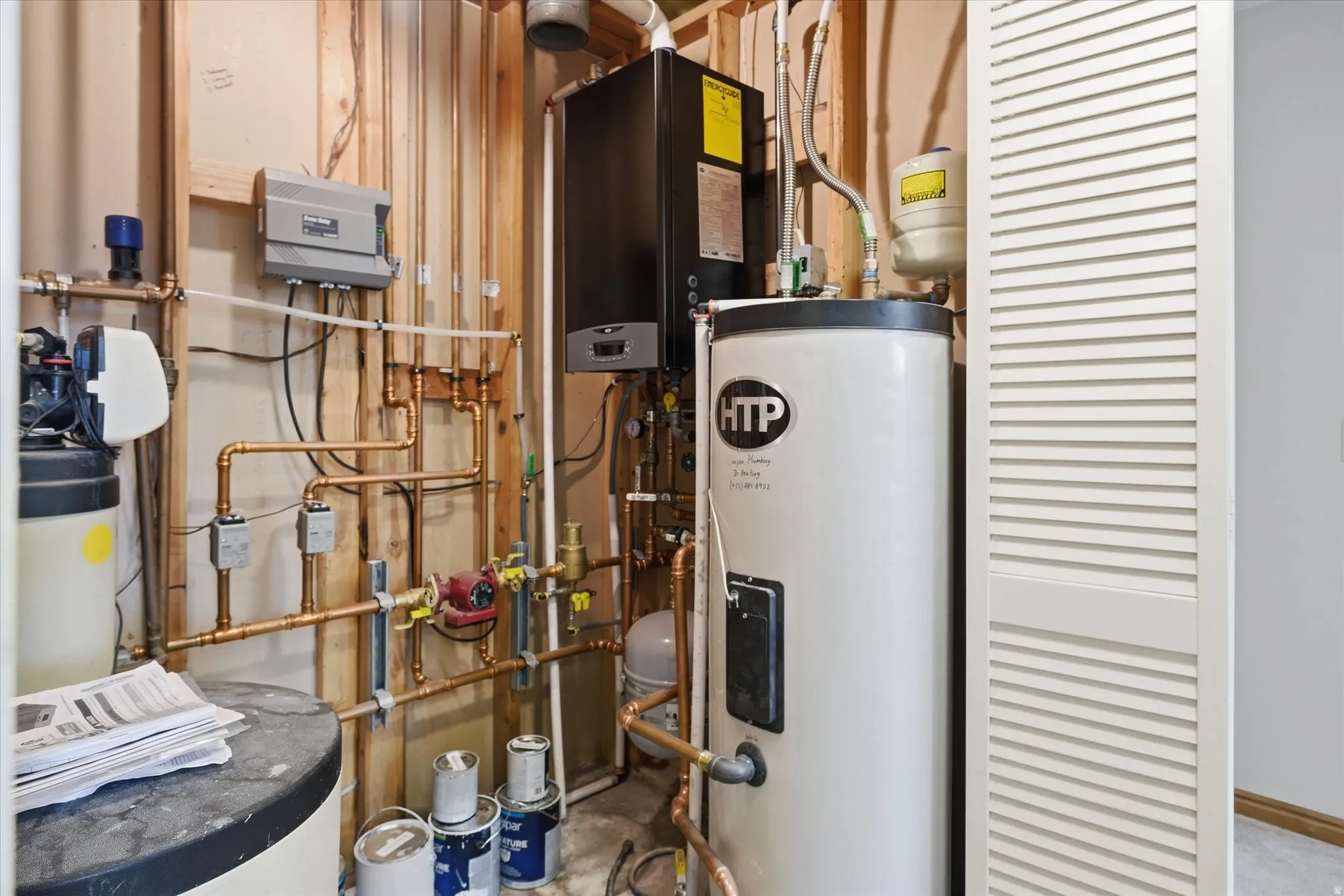 Utility room with water heater and tankless water heater