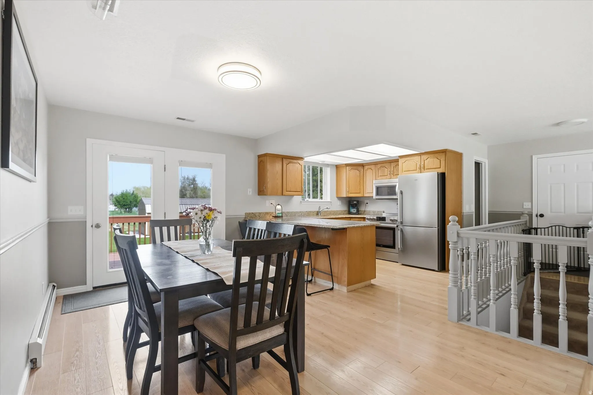 Dining space featuring light wood finished floors and baseboard heating