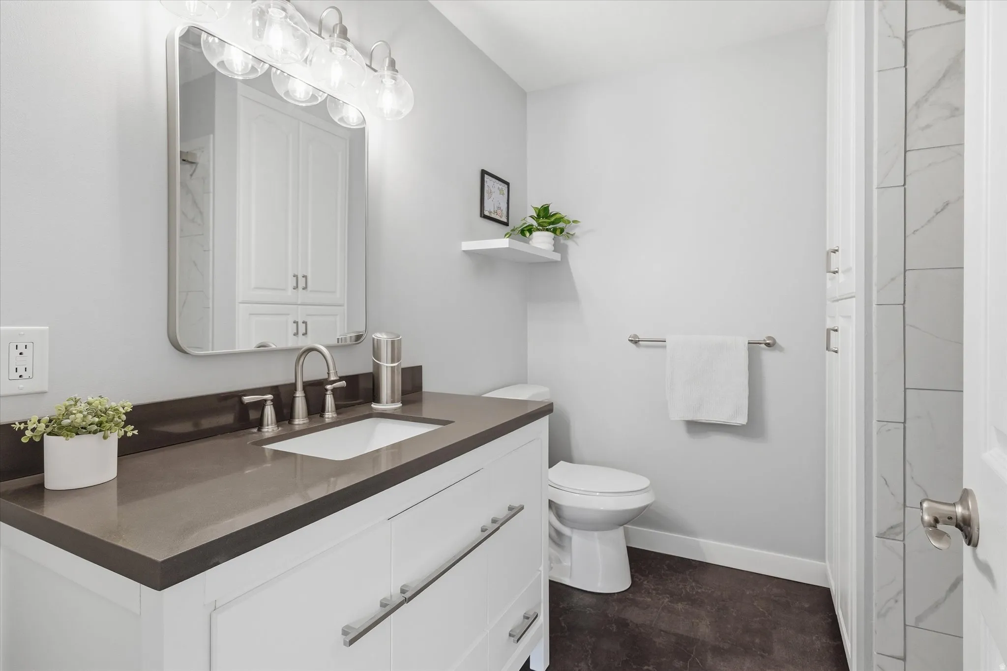 Bathroom featuring vanity and a closet