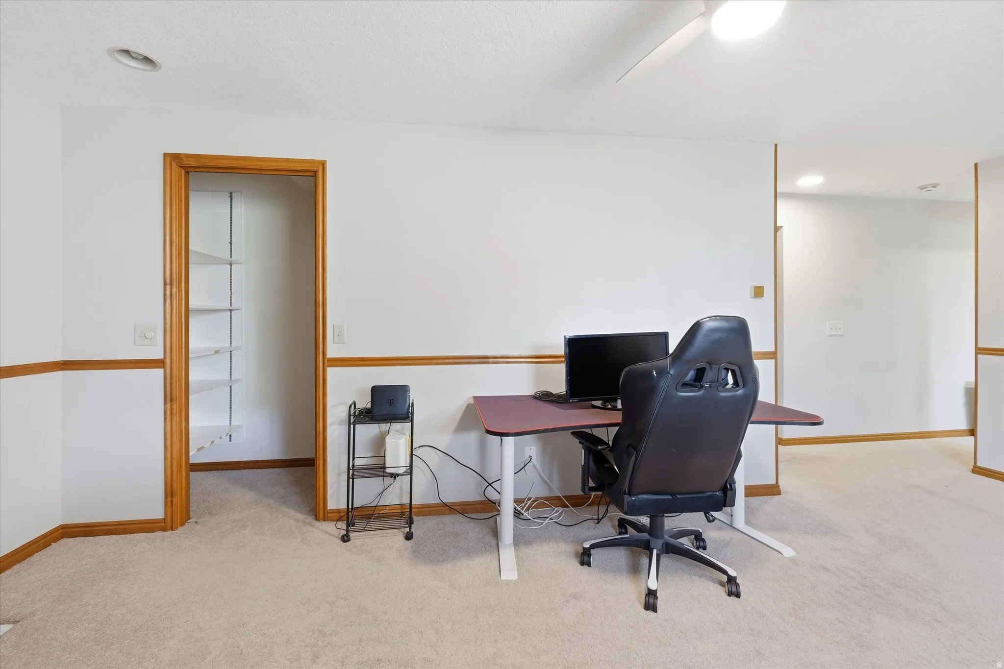 Office space with light carpet, recessed lighting, and a ceiling fan