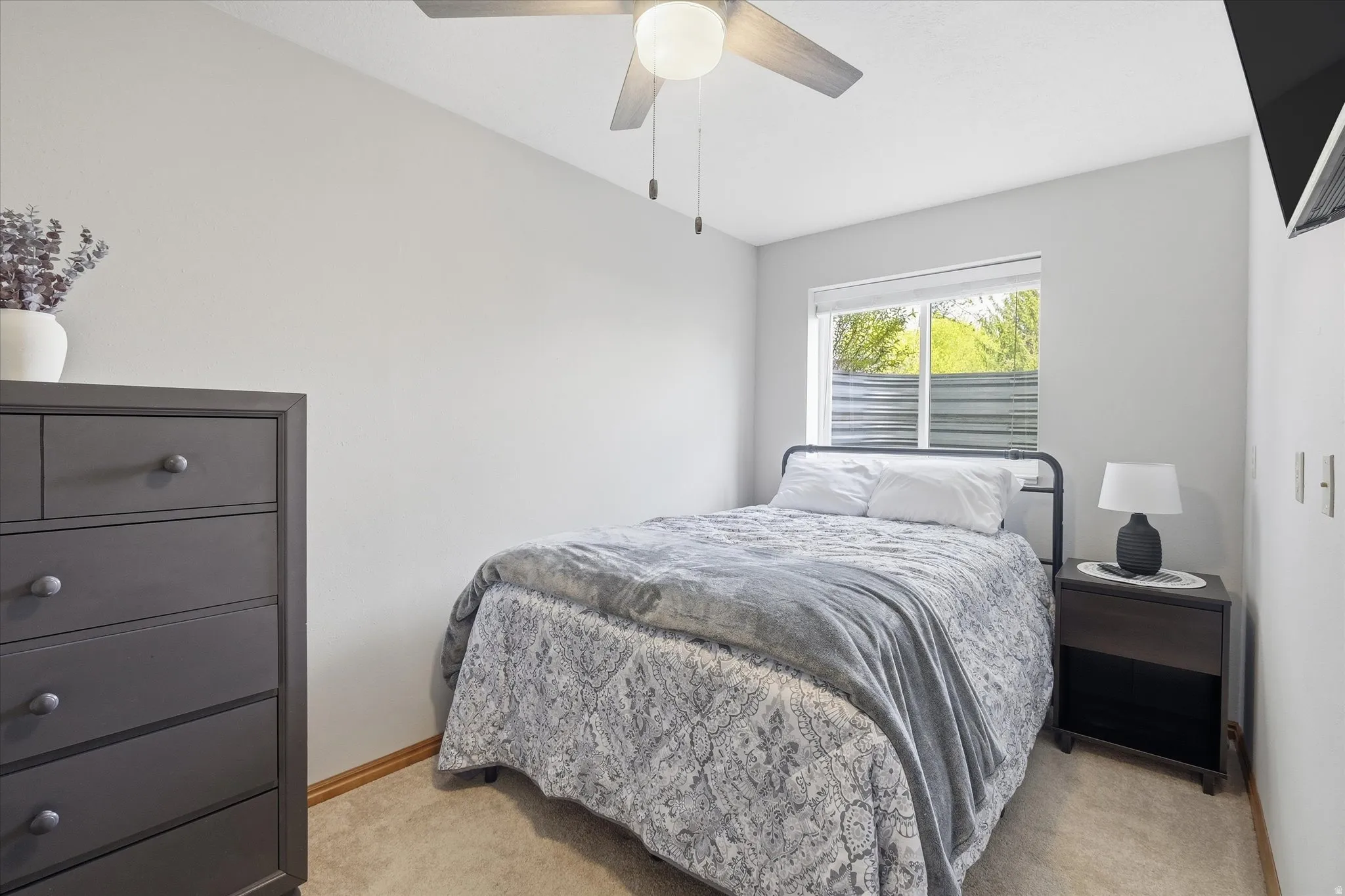 Bedroom featuring ceiling fan and light colored carpet