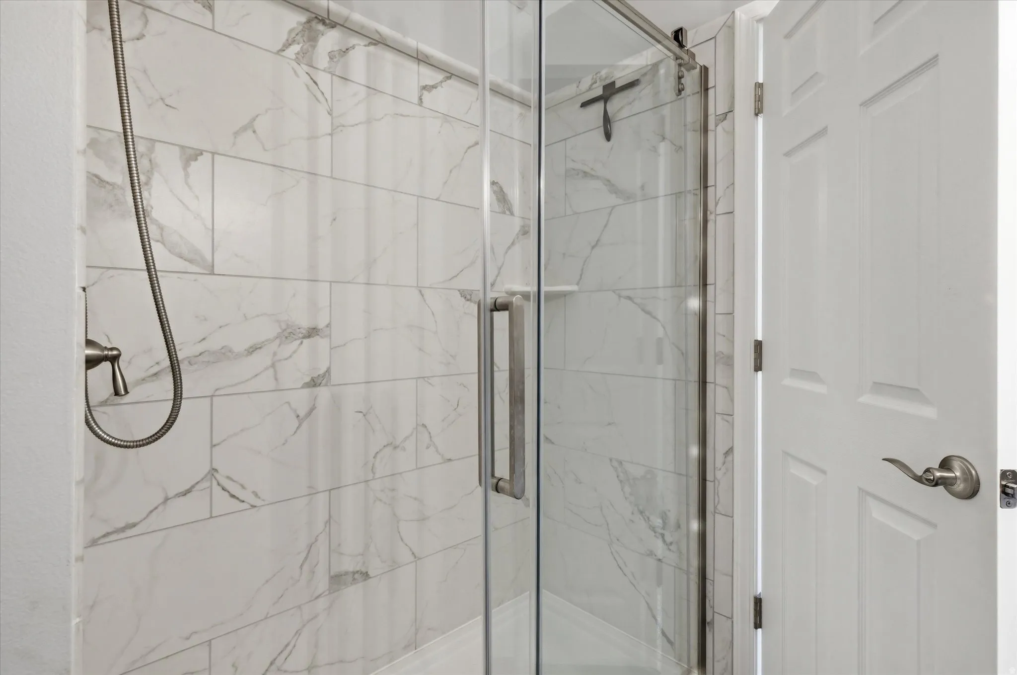 Bathroom with a marble finish shower