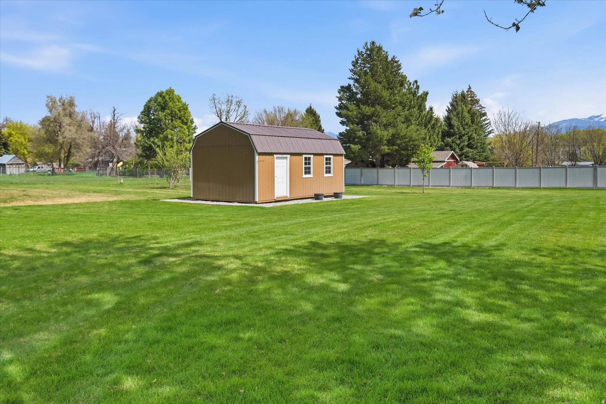 Fenced yard with a storage shed