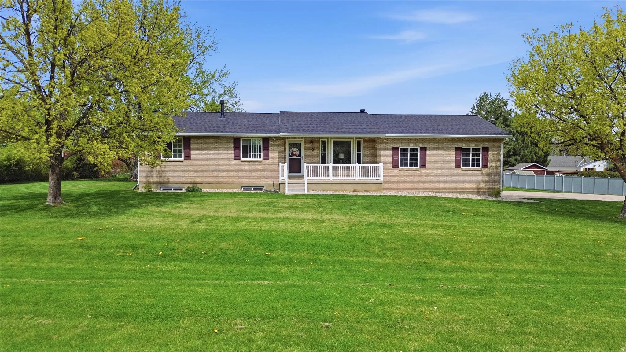Ranch-style house with covered porch and brick siding