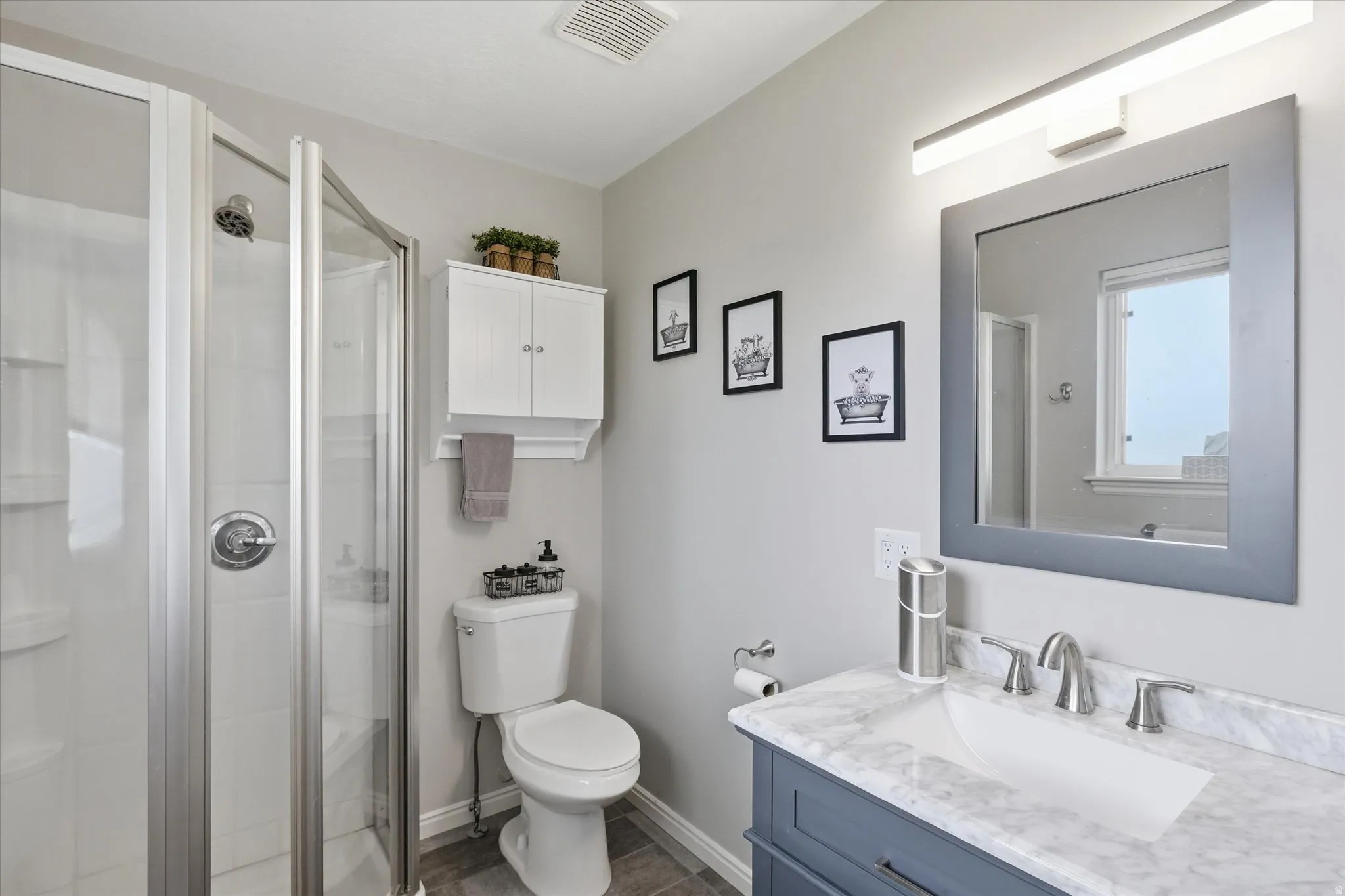 Full bathroom with vanity and a stall shower