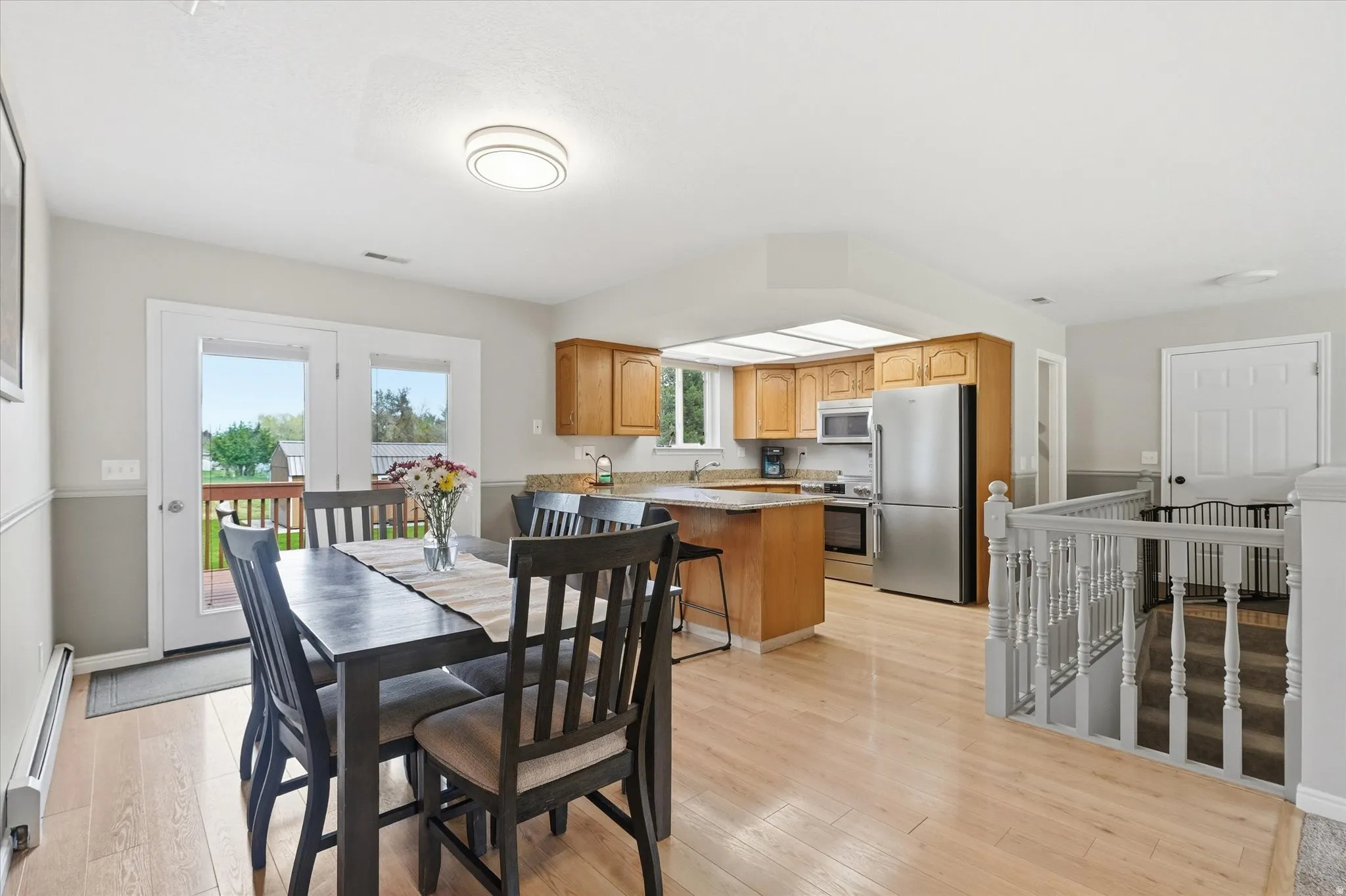 Dining space with light wood-style flooring and baseboard heating