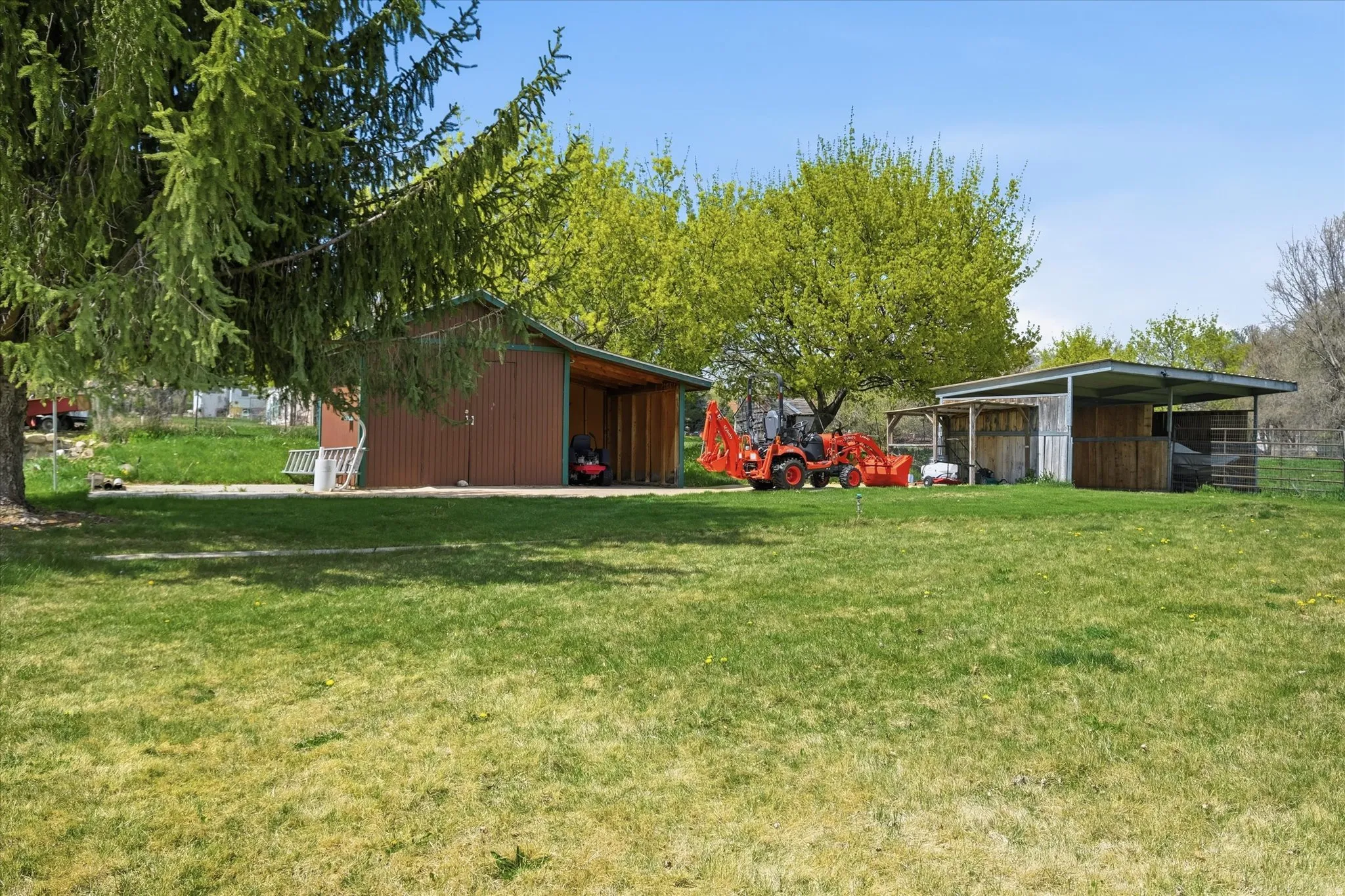 View of green lawn featuring a pole building and an outdoor structure