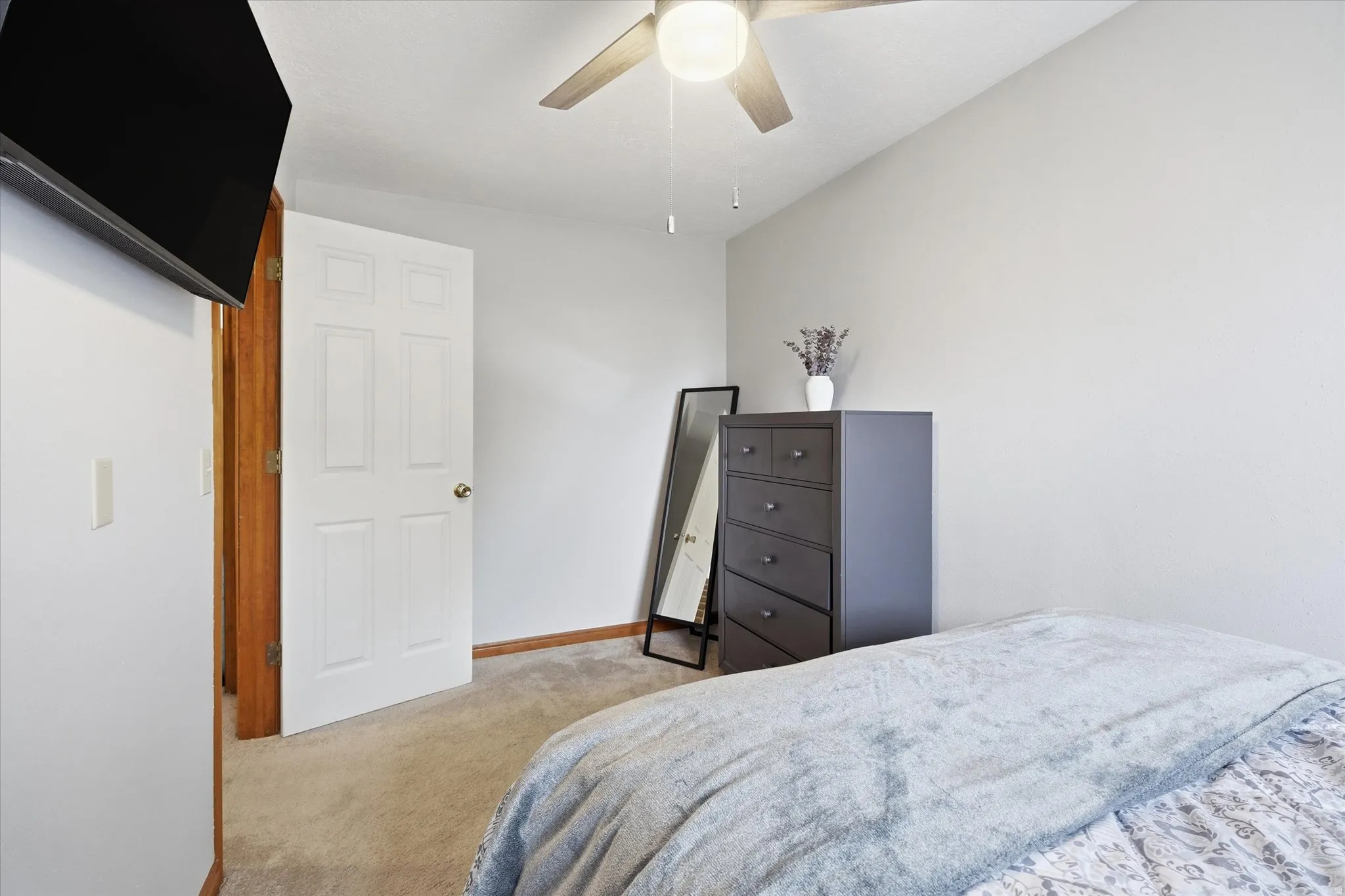 Bedroom featuring light colored carpet and ceiling fan
