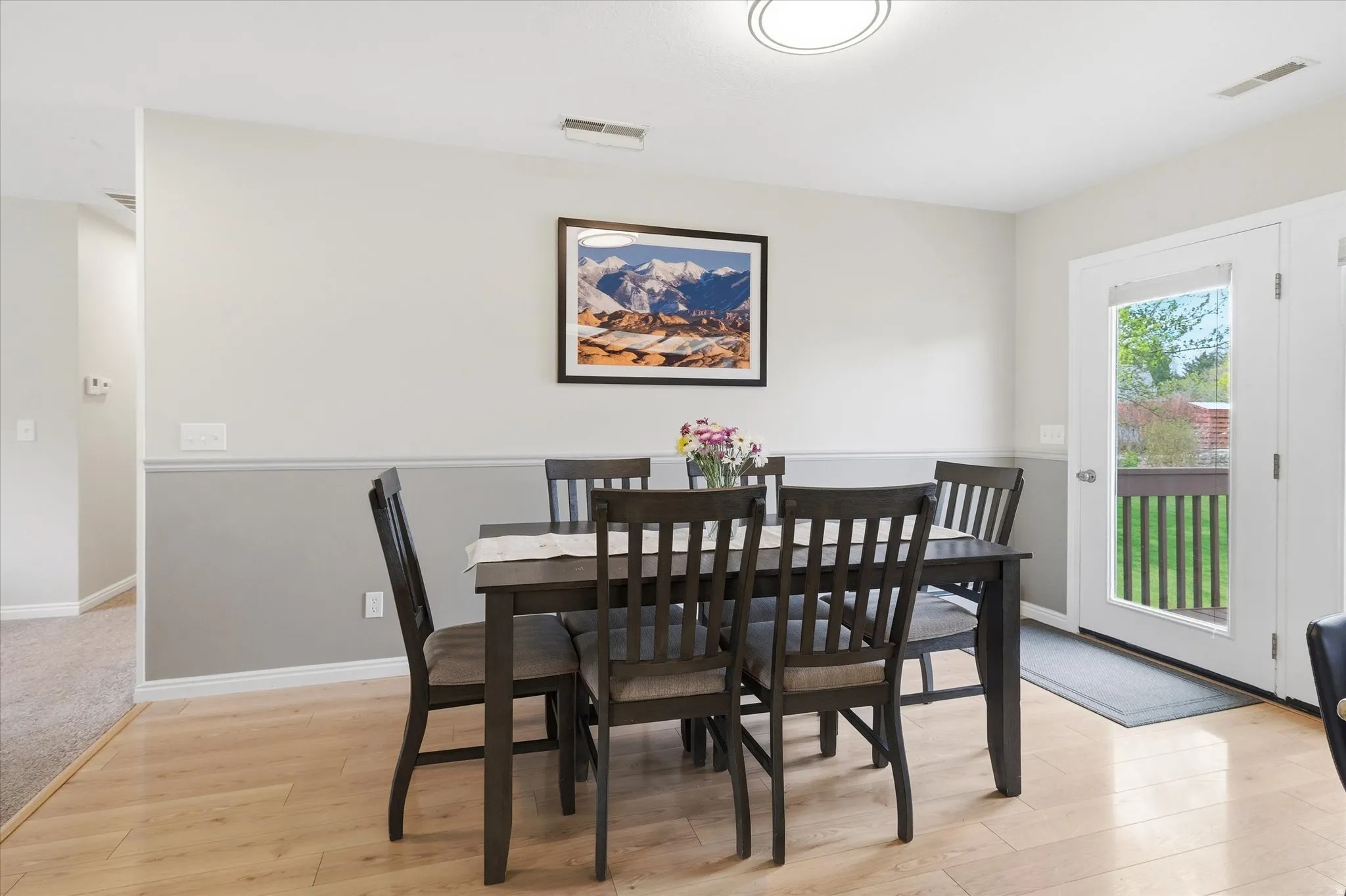 Dining space with light wood-type flooring and baseboards