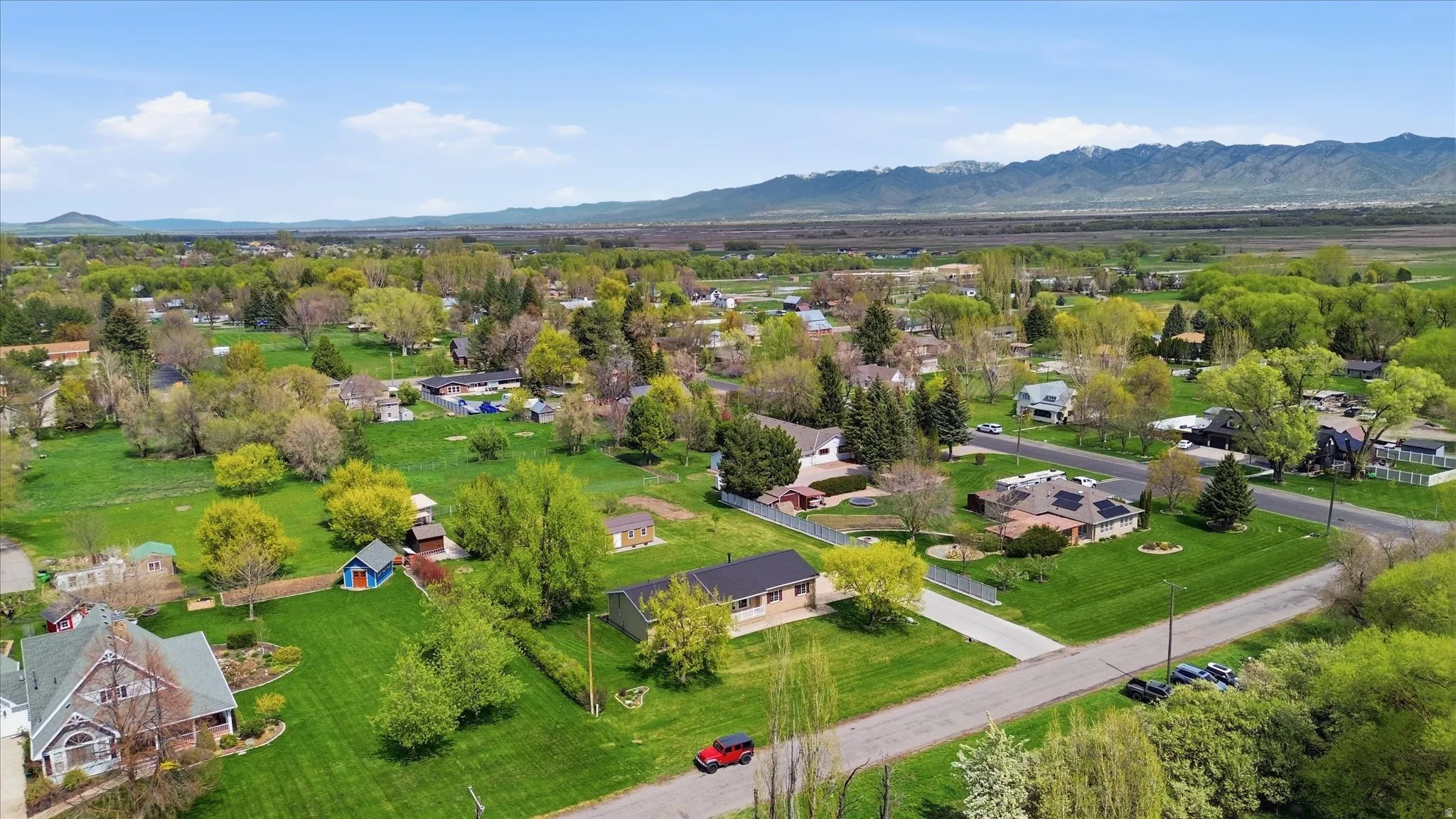 Aerial view of residential area featuring a mountainous background