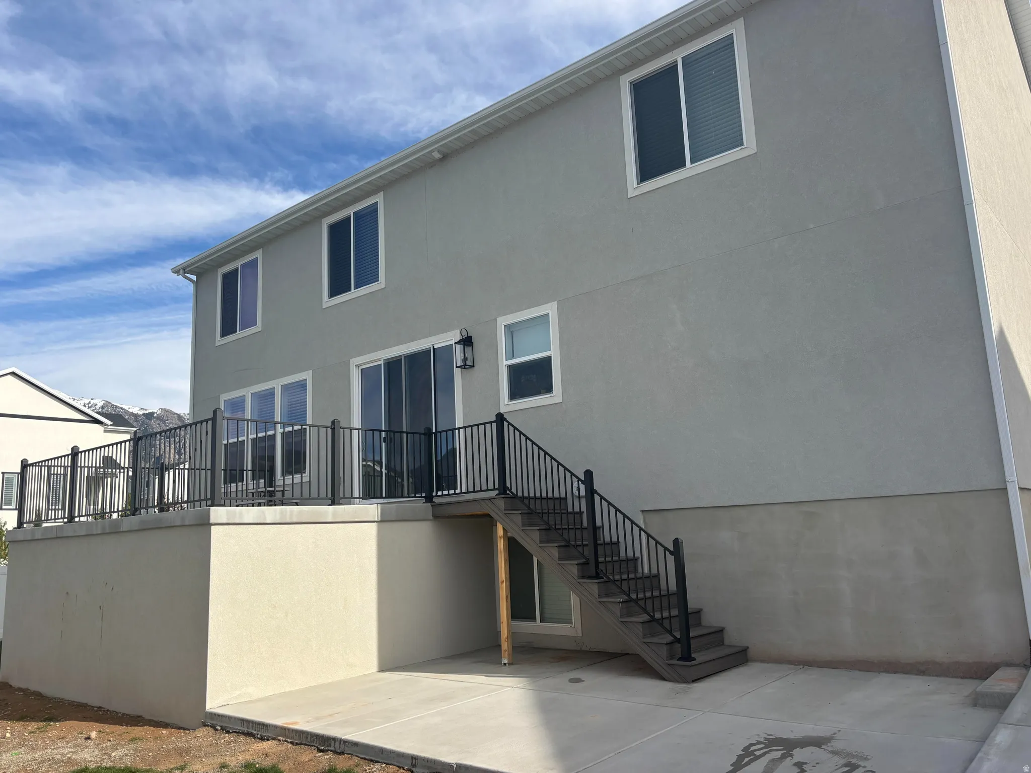 Concrete deck situated above storage room addition