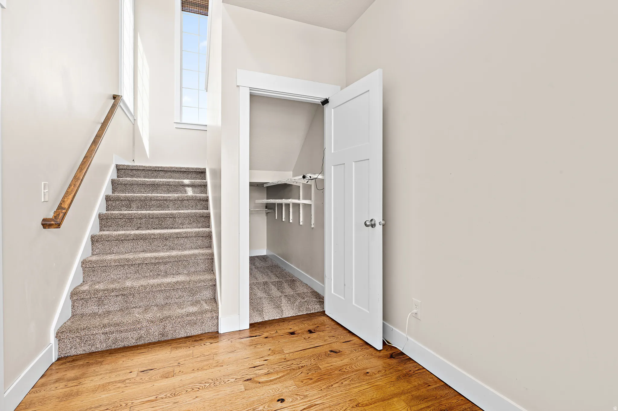 Stairway featuring wood finished floors and baseboards
