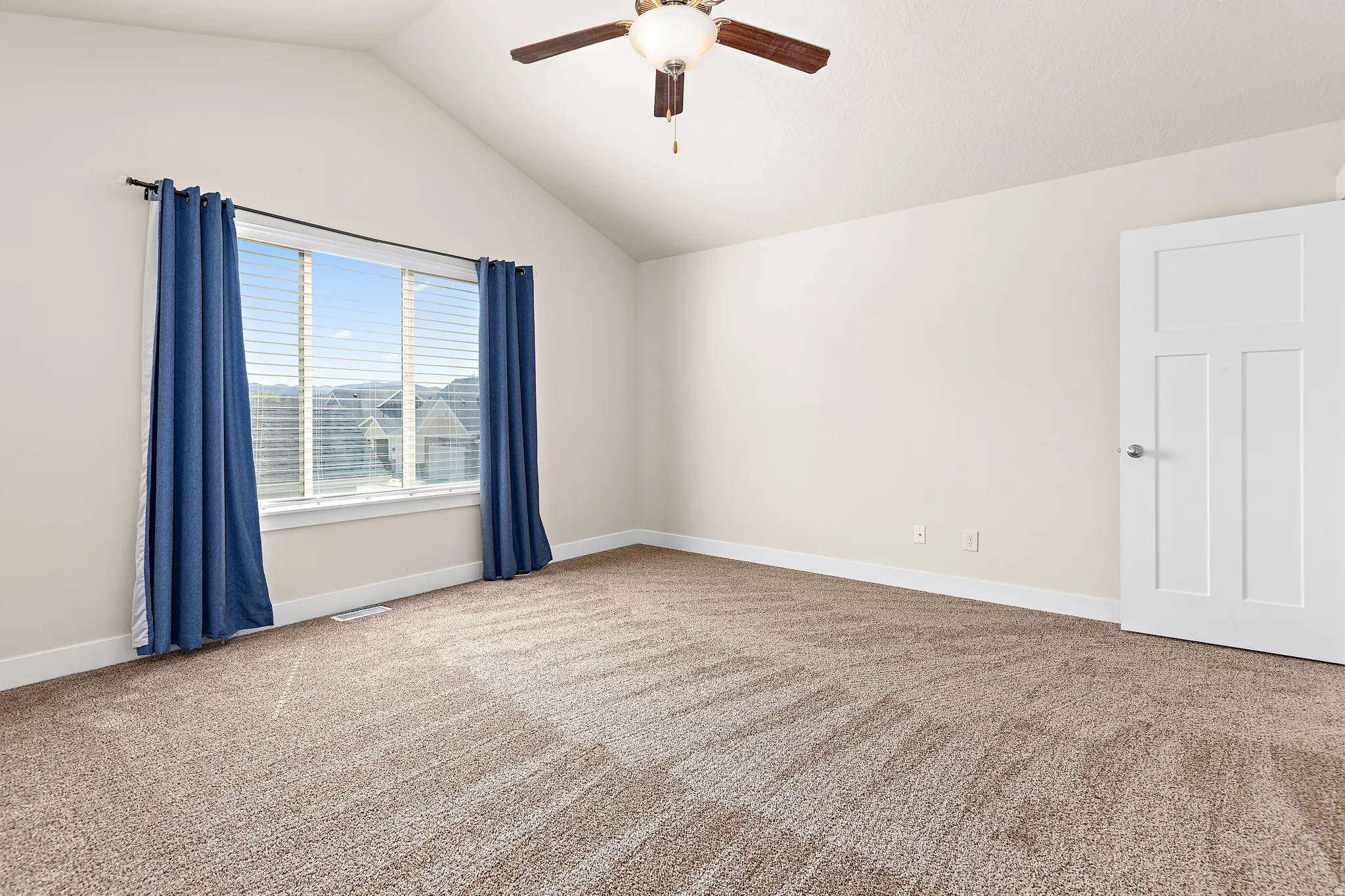 Unfurnished room featuring ceiling fan and light carpet