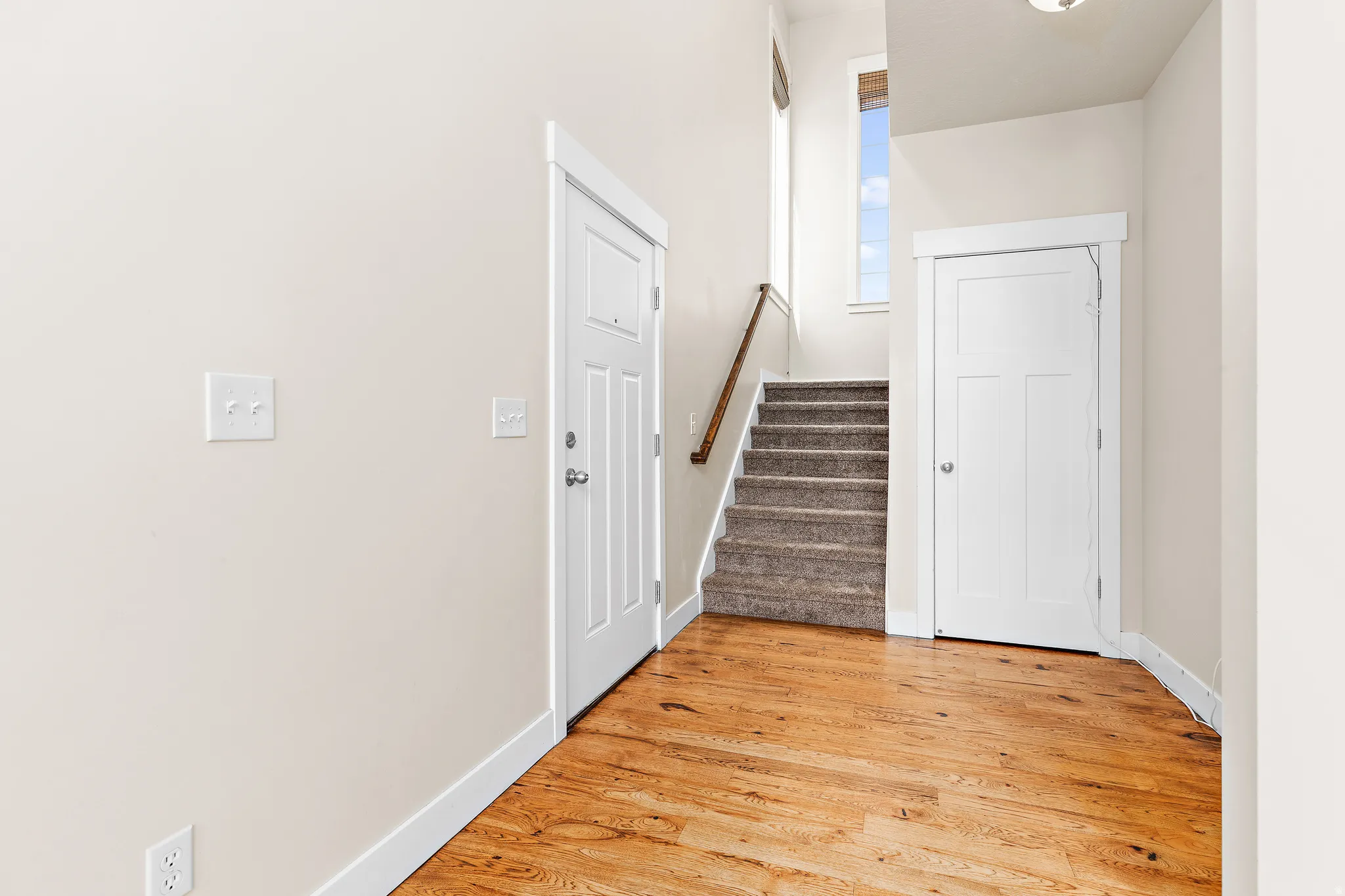Foyer featuring stairs and light wood-type flooring
