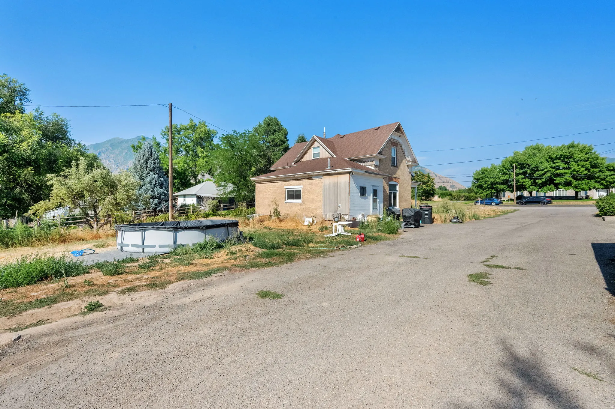 View of property exterior featuring a covered pool