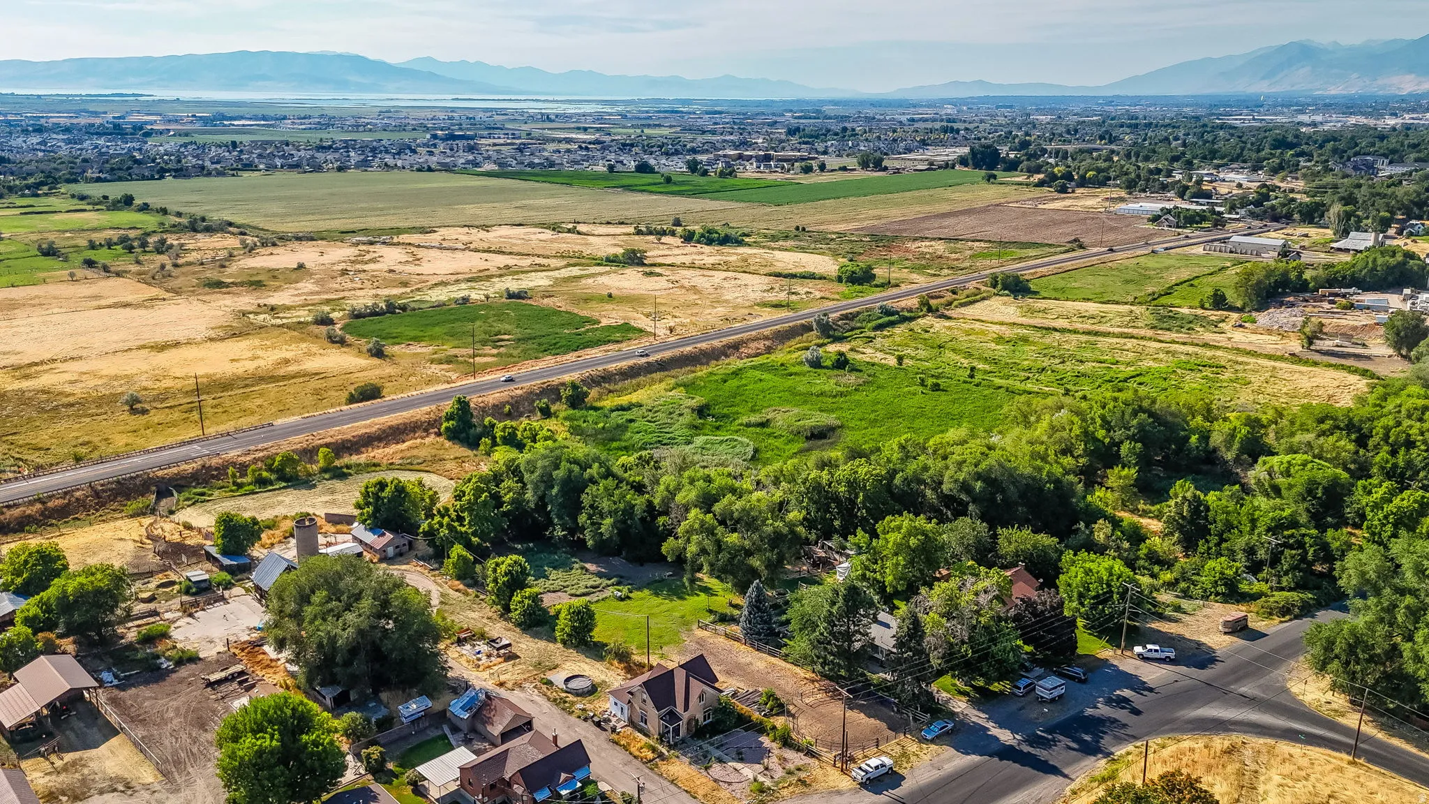 Aerial view of sparsely populated area with a mountain backdrop and nearby suburban area